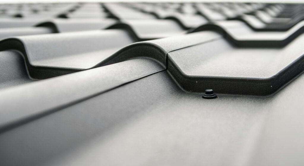 Close-up view of a metal roof's wavy design showcasing rivets and structural detail.